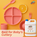 Baby's feeding cutlery with orange slice and GleamSure Dishwash Liquid bottle labeled 'Best for Baby’s Cutlery'.
