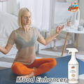 Gleamsure room freshener next to a man meditating or relaxing, emphasizing the product as a ‘Mood Enhancer’.